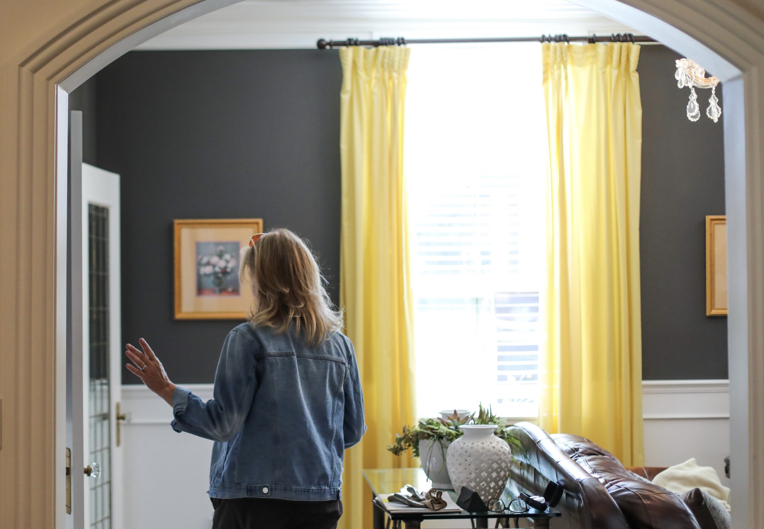 woman walking around a house flip