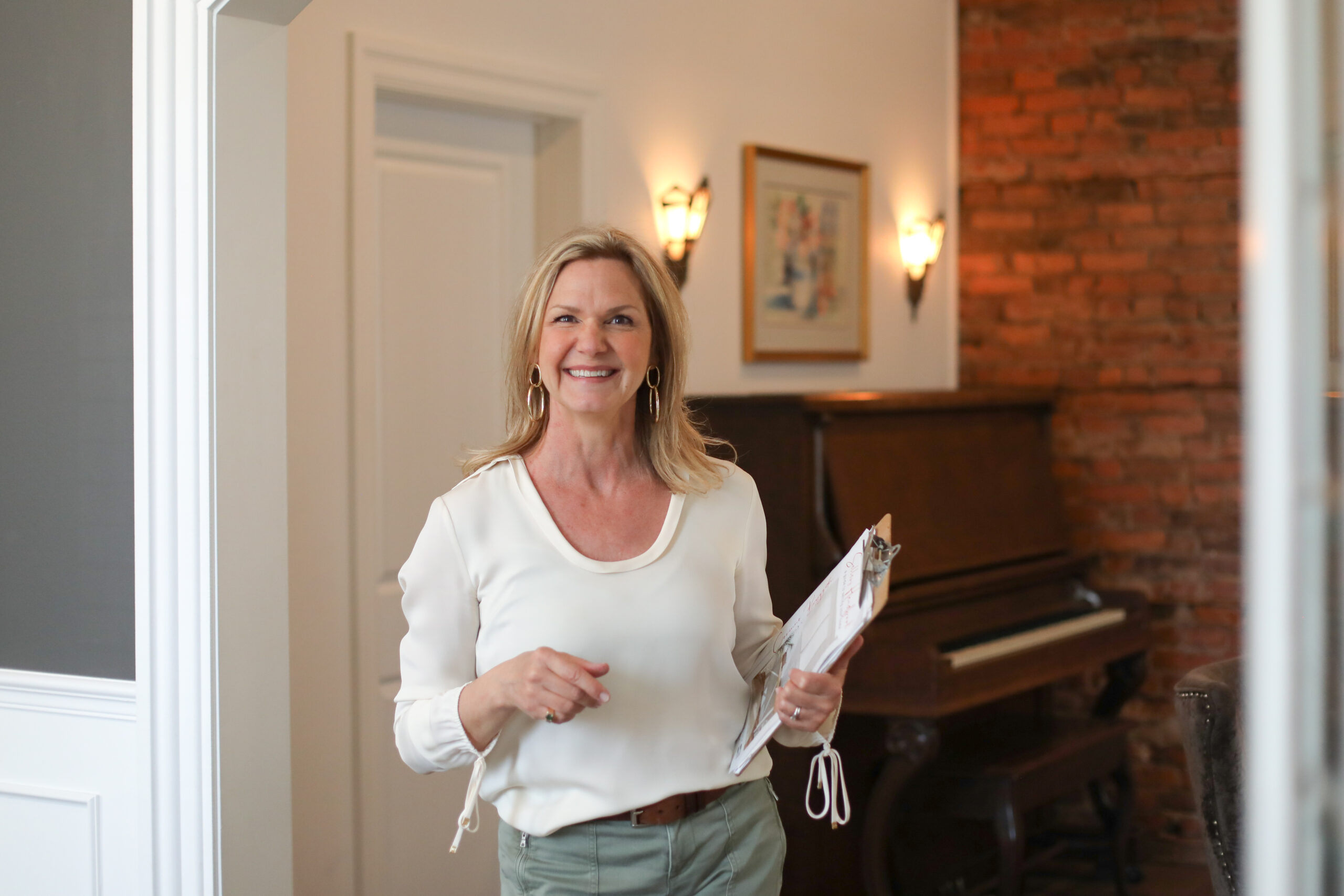 woman holding clipboard in renovated house