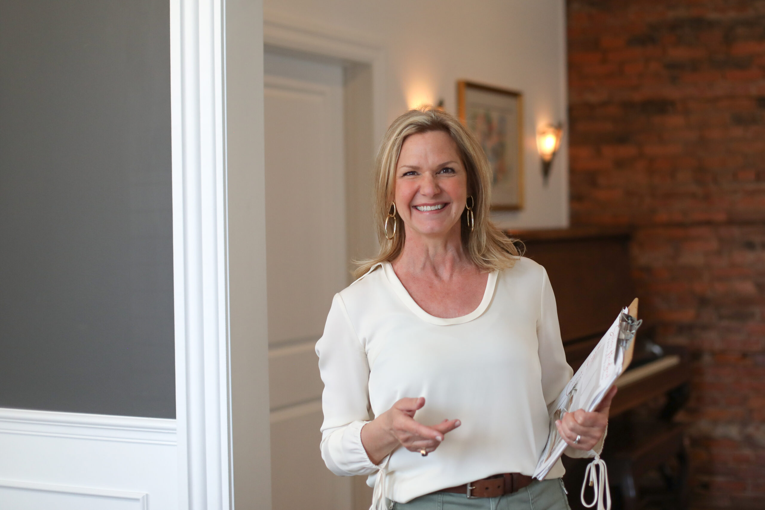 woman holding clipboard in renovated house