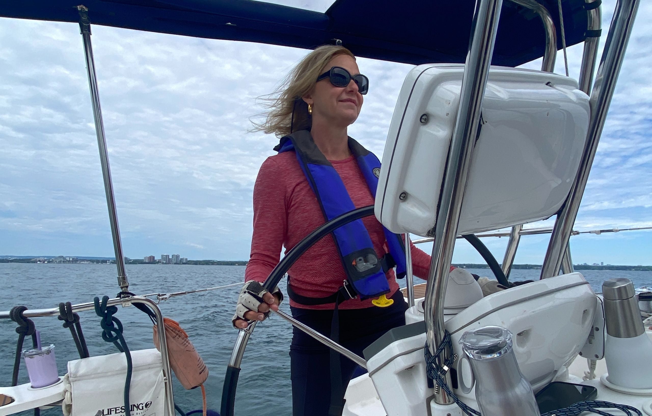 woman on a sailboat learning to sail